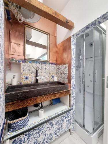 a bathroom with a sink and a shower at Casa vacanza in lipari ,PIANO PIANO in Lipari