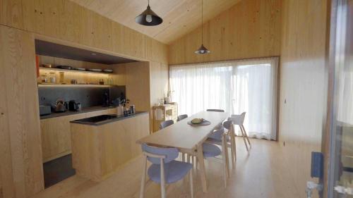 a kitchen and dining room with a table and chairs at Natura Natura in Paredes