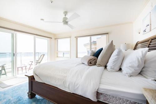 a bedroom with a large white bed with white pillows at Luxury Penthouse with Elevator - Sleeps 10+ - Family Friendly Sun / Surf / Sand in San Diego