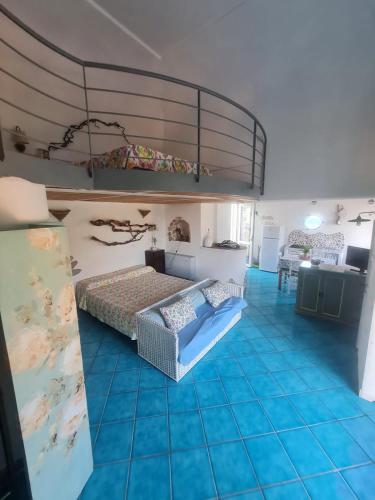 a bedroom with a large bed and blue tiled floors at Le Case dei Pescatori - Mare Blu in Ponza