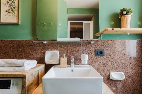 a bathroom with a sink and a mirror at Relax at the mountain in Madonna di Campiglio