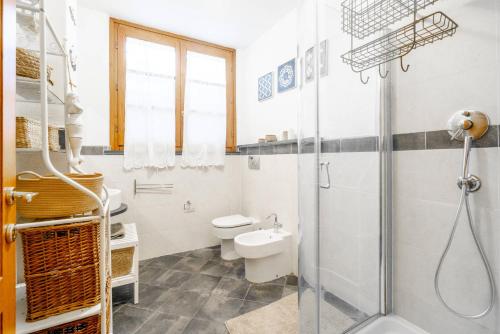 a bathroom with a shower and a toilet and a sink at Villa Lorenzo in Querceta