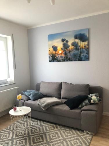 a living room with a couch and a painting on the wall at Apartment Bad Breisig in Bad Breisig