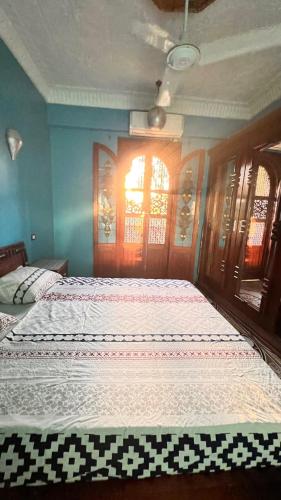 a bedroom with two beds and a window at Villa Barba Luxor in Luxor