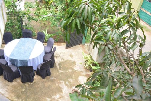 a table and chairs in a garden with a table and chairs at UR Villa in Waskaduwa