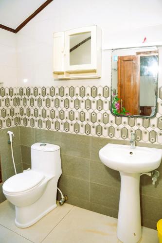 a bathroom with a toilet and a sink at Rajahamsam Houseboat in Kumarakom