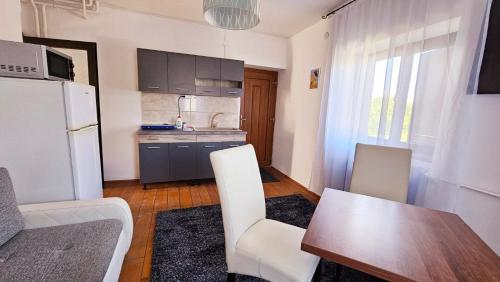 a kitchen with a table and chairs and a refrigerator at Ciao Bambino! in Fonyód