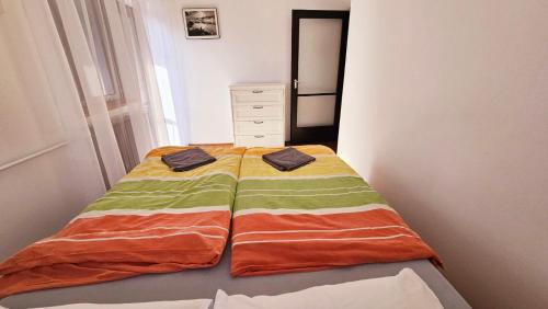 a bed with two towels on it in a bedroom at Ciao Bambino! in Fonyód