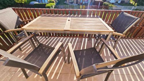 a wooden picnic table and chairs on a deck at Ciao Bambino! in Fonyód