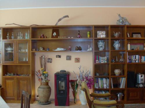 a room with wooden shelves and a book shelf at Il Melicucco in Furci Siculo
