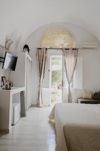a bedroom with a bed and an open door at Miro B&B in Lecce