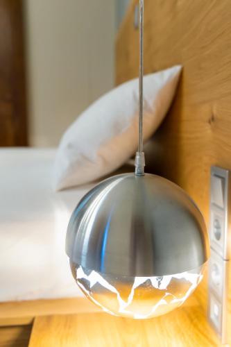 a glass bowl on a table next to a bed at Armenopetra View Gerolimenas in Gerolimenas