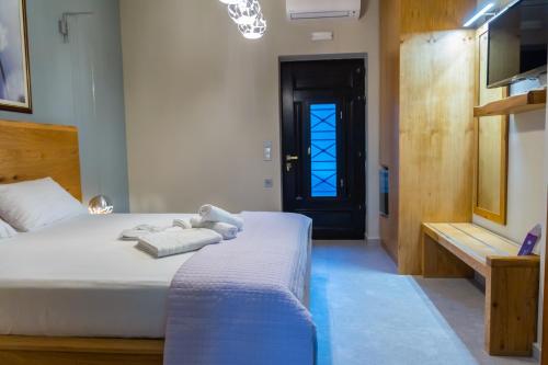 a bedroom with a bed with a teddy bear on it at Armenopetra View Gerolimenas in Gerolimenas