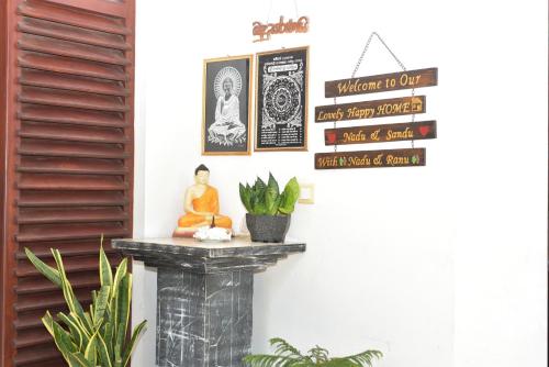 a room with a table with a statue on it at UR Villa in Waskaduwa