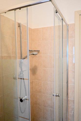 a shower with a glass door in a bathroom at Miro B&B in Lecce