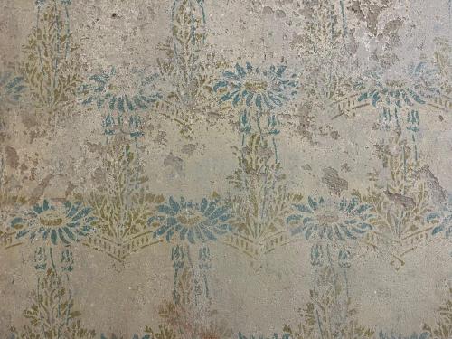 an old wallpaper with blue flowers on it at Apartmá Juliana 1905 in Karlovy Vary