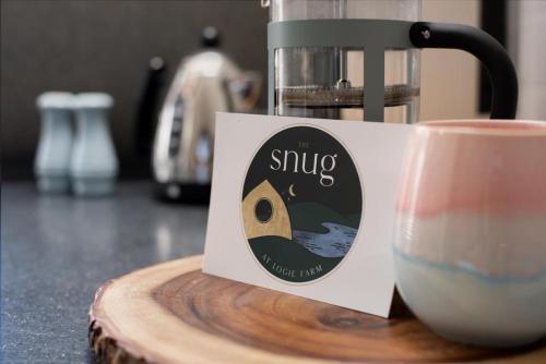 a sign next to a cup of coffee on a counter at Luxurious Snug with hottub which sleeps-2 in Fife in Newburgh
