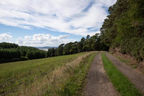 a dirt road in the middle of a field at Luxurious Snug with hottub which sleeps-2 in Fife in Newburgh