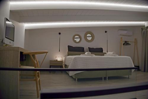 a bedroom with a large bed and two mirrors at Villa Mourelo luxury villa in chania with private pool jacuzzi in Chania Town