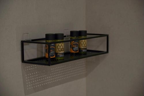 a shelf with four bottles of honey on it at Villa Mourelo luxury villa in chania with private pool jacuzzi in Chania Town