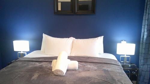 a bedroom with a bed with two towels on it at E&J Boutique Residences in Sosúa