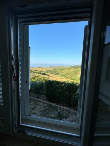 a window with a view of a field at Restorant Hotel Niku in Durrës
