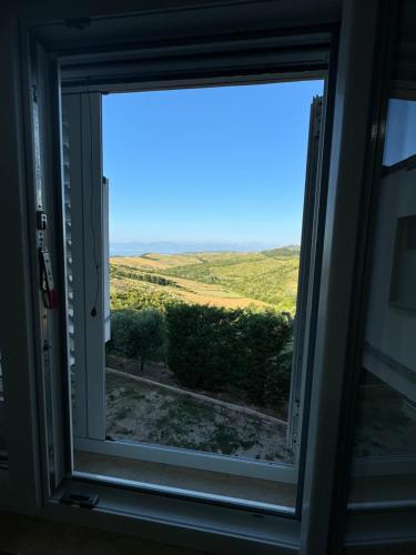 a window with a view of a field at Restorant Hotel Niku in Durrës