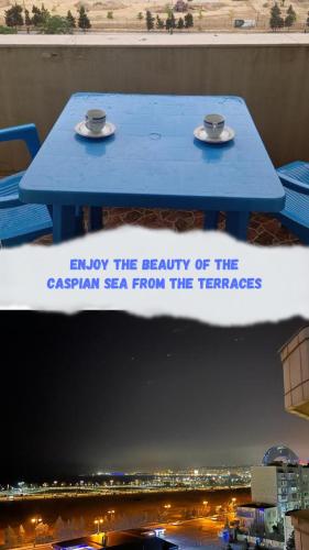 a blue table with two cups on top of it at Sea view couple apartmant at boulvard,near nizami street in Baku