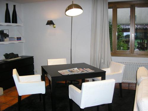 a dining room with a table and white chairs at Don Carlos in Huarte