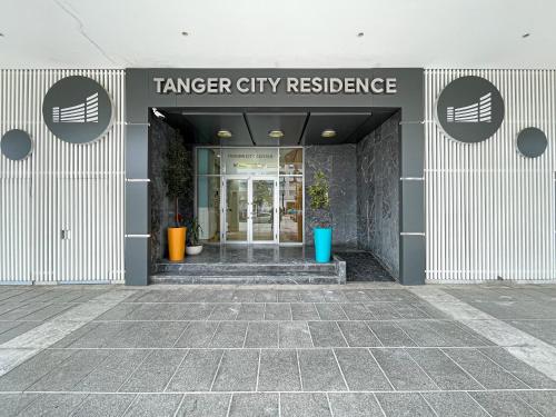 a building with a sign that reads transfer city residence at LUXURY Hilton City Center residence 5A GUEST FRIENDLY in Tangier
