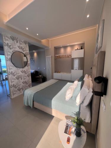 a bedroom with a large bed and a table at IL MARE BLU in Lerici