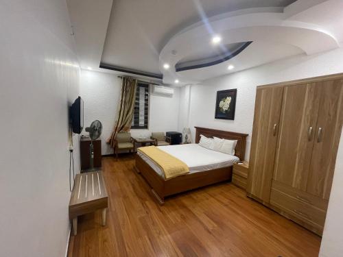 a bedroom with a bed and a tv in it at Đông Đô Hotel in Hai Phong