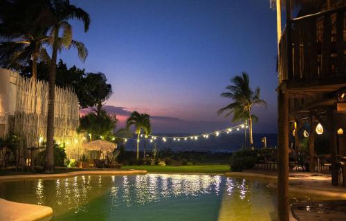 a swimming pool at night with a string of lights at Hurricane Jeri in Jericoacoara