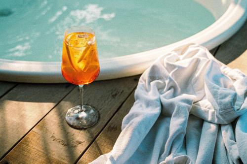 a wine glass sitting on a table next to a bath tub at Hurricane Jeri in Jericoacoara