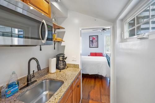 a kitchen with a sink and a room with a bed at Villa Mulvey # 3 in St. Augustine