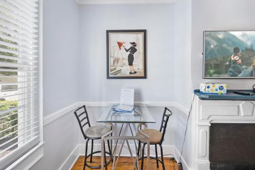 a table and chairs in a room with a fireplace at Villa Mulvey # 3 in St. Augustine