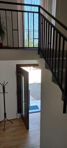 a hallway with a staircase with a door and a window at Casa Bino in Purgèssimo