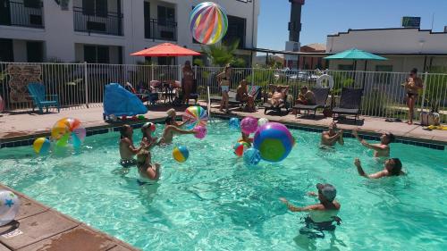 a group of people playing in a swimming pool at Ramada by Wyndham Kingman in Kingman