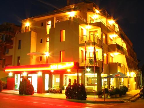 a large building with lights in front of it at Tabanov Beach Hotel in Sozopol