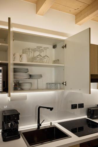 a kitchen with a sink and a counter top at Apartment Alpen Dolomites in Selva di Cadore