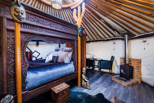 a bedroom with a bed in a tent at Lincoln Yurts in Lincoln