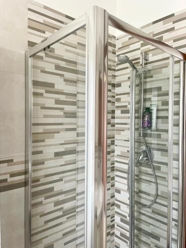 a shower with a glass door in a bathroom at Casa Lucia in Lignano Sabbiadoro