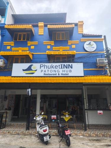 two motorcycles parked in front of a building at Phuket Inn Patong Hub in Patong Beach