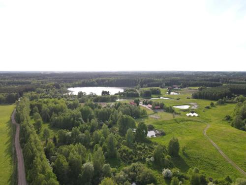 an aerial view of a field and a lake at Highland Warmia - Gospodarstwo agroturystyczne in Jeziorany