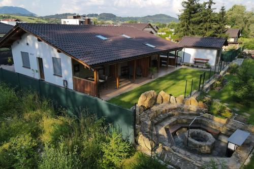 an aerial view of a house with a stone wall at Villa Garden in Bešeňová