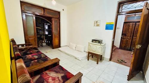 a living room with a couch and a table at Muffys Apartment in Old Goa