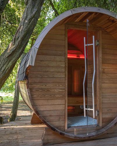 a round wooden sauna in a tree house at Baumhaus Solitär in Borstel