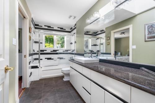 a bathroom with two sinks and a toilet at The West Vancouver luxurious house in West Vancouver