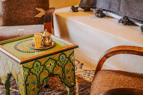 a table with a tea set on top of it at Hotel & Spa La Ferme El Dar in Marrakech