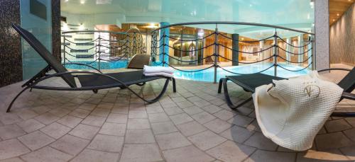 a room with a table and chairs and a balcony at Galaxy Hotel in Kraków